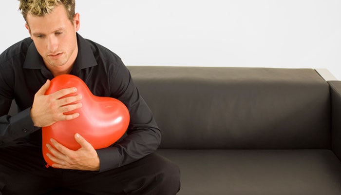 man-holding-heart-balloon